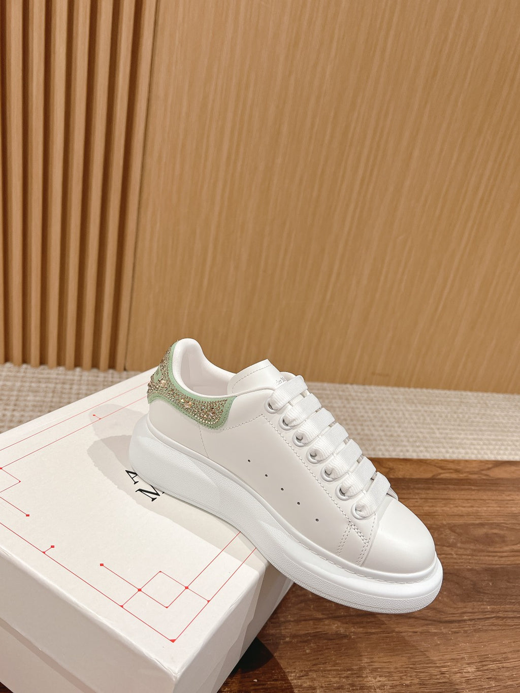 White leather low-top sneakers with green glitter heel panel