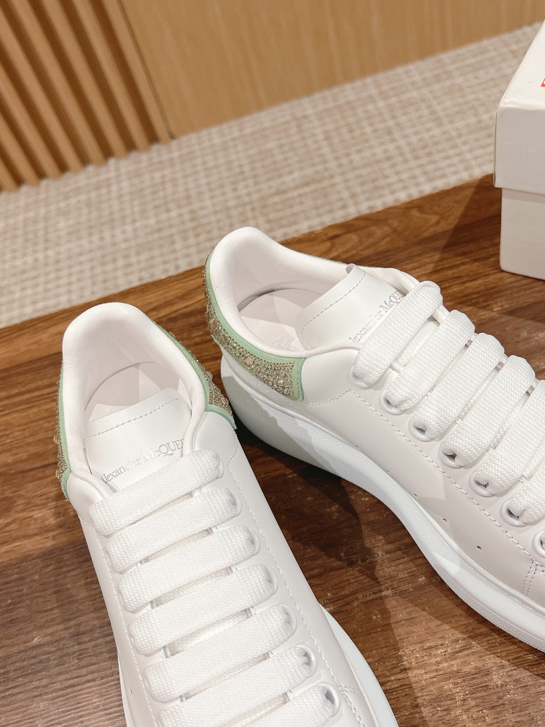 White lace-up sneakers with green glitter collar, shown from side and back