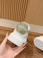 White leather sneaker close-up, green heel patch with glitter texture