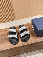 Dior slide sandals, black footbed with white monogram straps and silver buckles