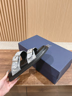 Dior slide sandals held in hand, black sole with white monogram double strap