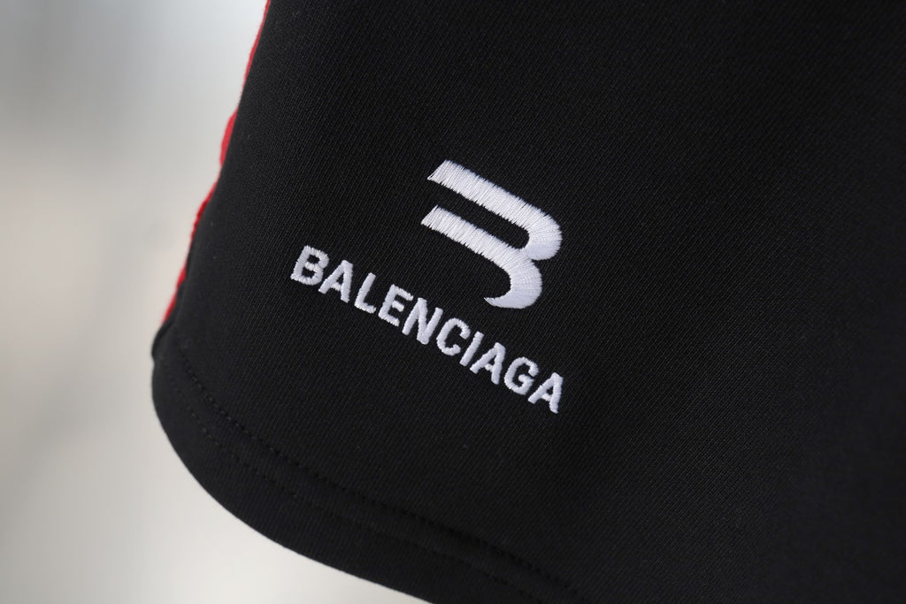 Balenciaga logo print on black shorts leg with white and red trim