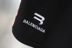 Balenciaga logo print on black shorts leg with white and red trim