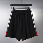 Black Balenciaga shorts with double side stripes and red trims