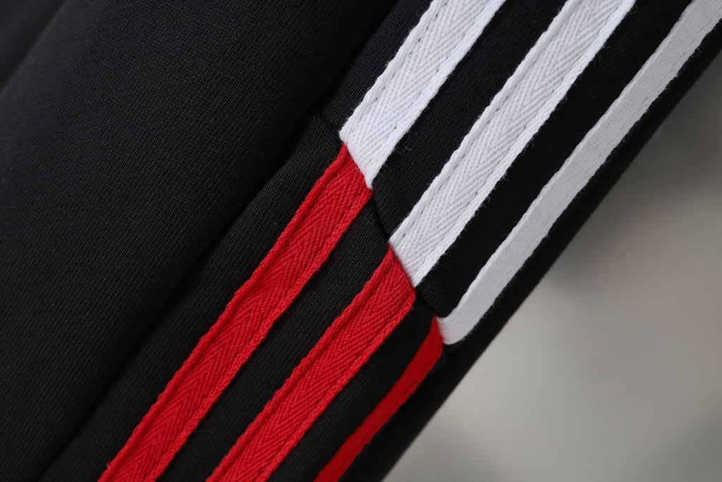Side stripe detail on black Balenciaga shorts with white stripes and red band