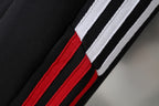 Side stripe detail on black Balenciaga shorts with white stripes and red band
