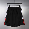 Black Balenciaga shorts with elastic waistband and side stripe accents
