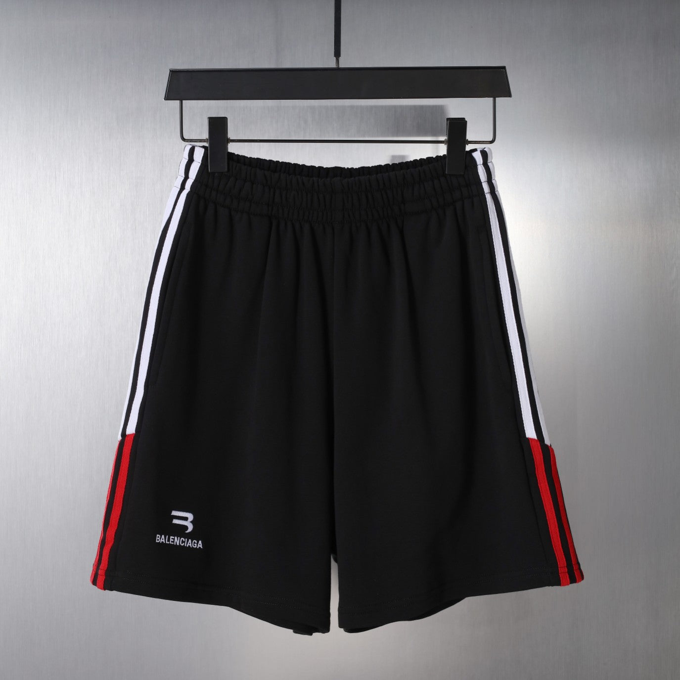 Black Balenciaga shorts with elastic waistband and side stripe accents