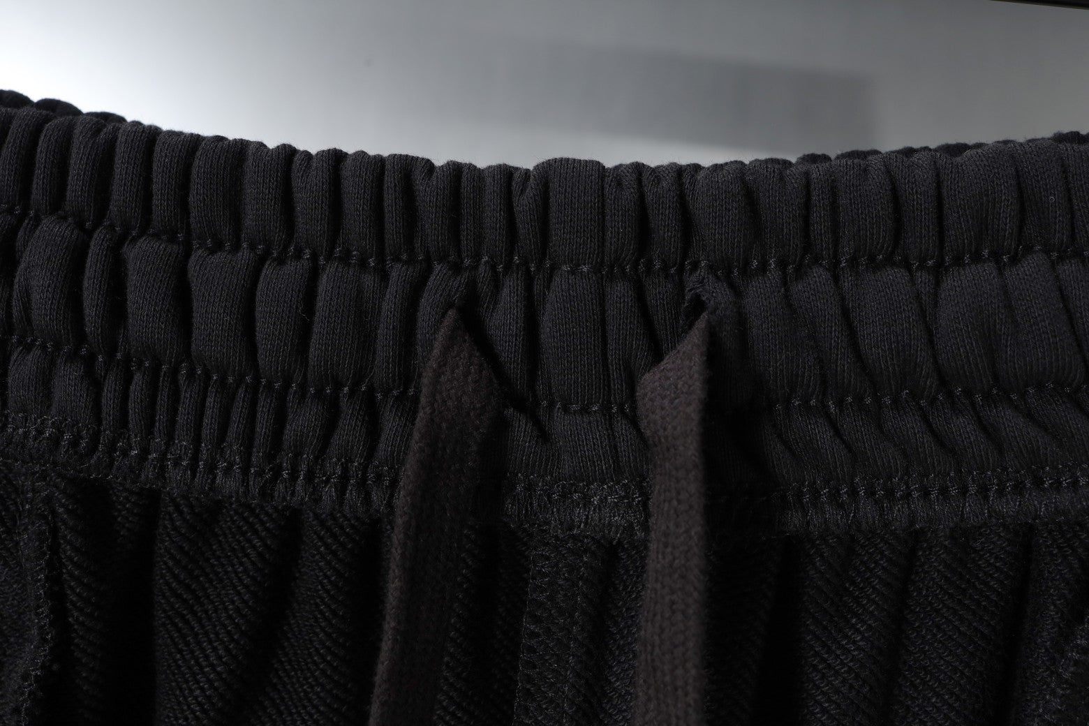 Black elastic waistband on Balenciaga shorts with stitched drawstring channel