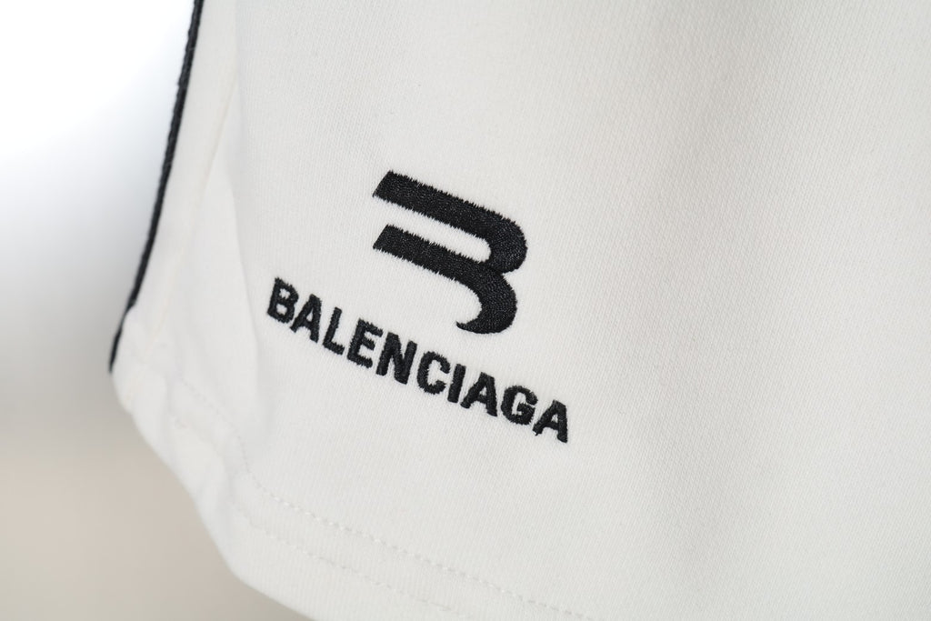 Close-up of Balenciaga logo print on white shorts