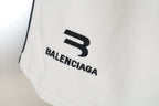 Close-up of Balenciaga logo print on white shorts