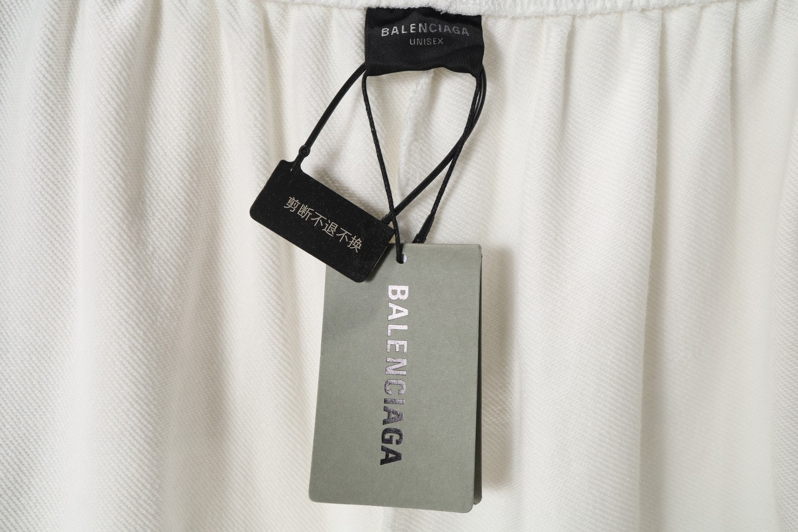 White shorts with attached Balenciaga and size tags