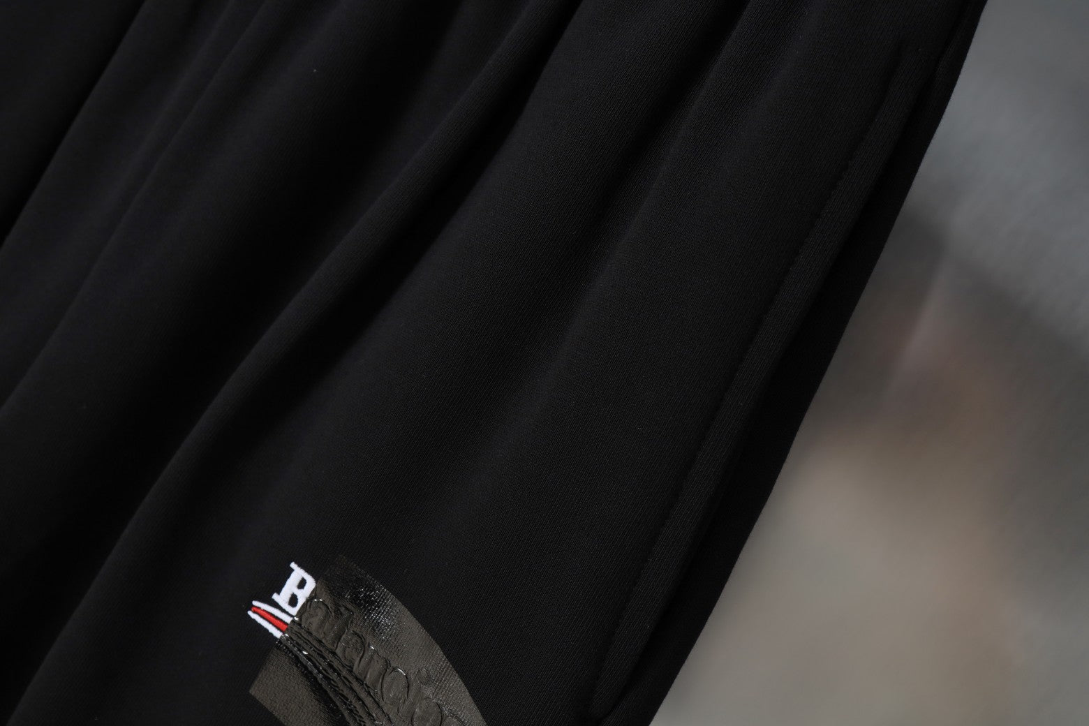Balenciaga black shorts with embroidered logo detail on fabric