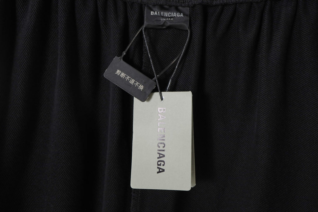 Balenciaga black shorts with attached size and brand tags at waistband