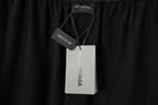 Balenciaga black shorts with attached size and brand tags at waistband