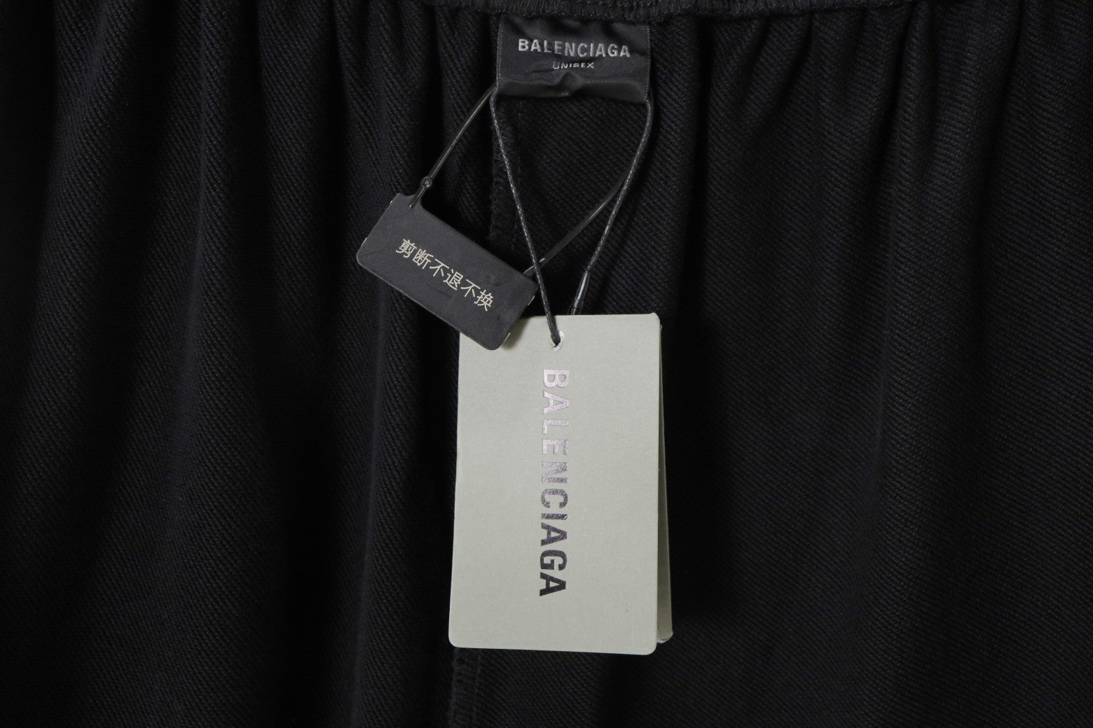 Balenciaga black shorts with attached size and brand tags at waistband