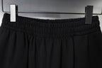 Balenciaga black shorts viewed from above on hangers with elastic waistband