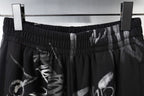 Black pants waistband with elastic gather and metallic clip detail