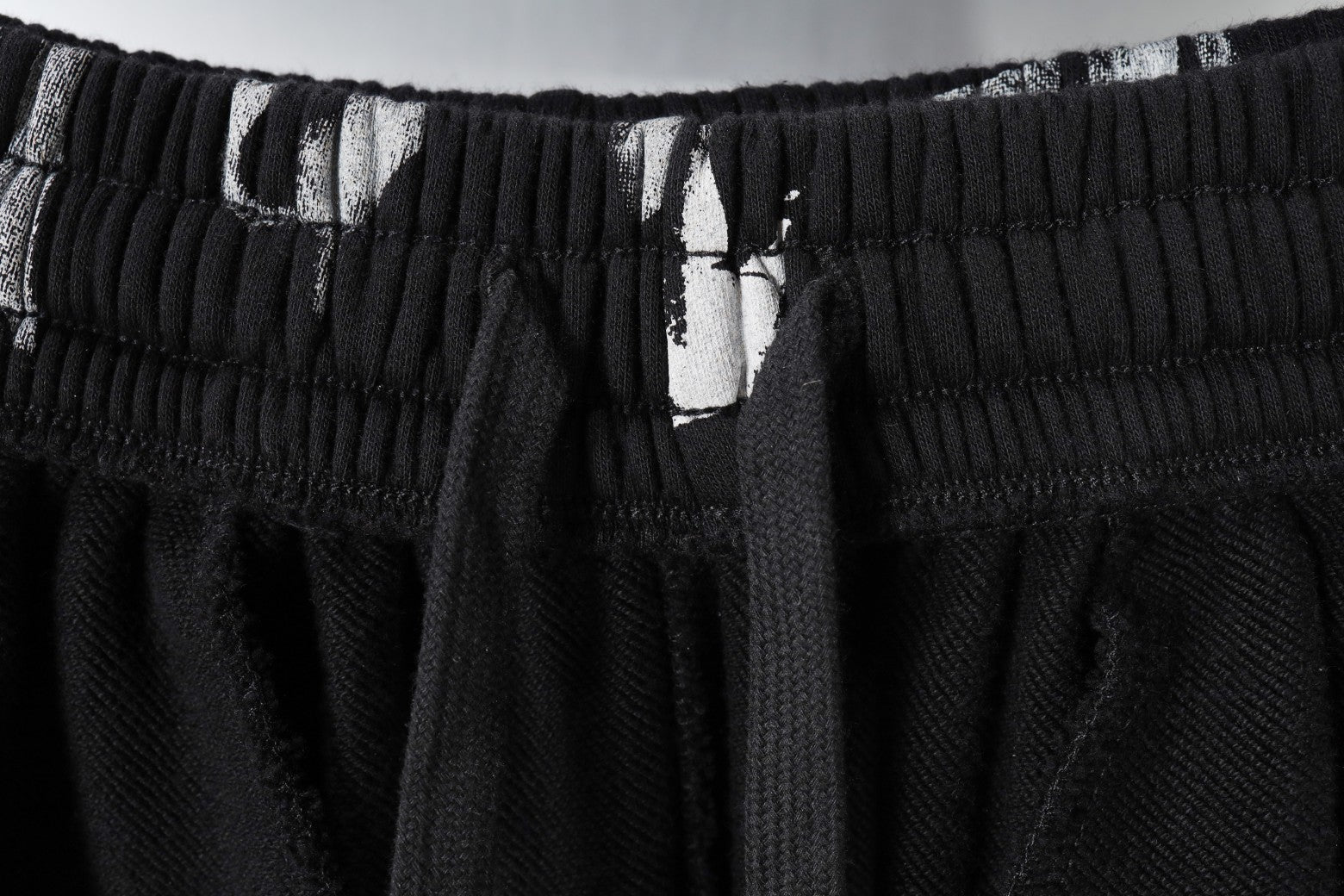 Black elastic waistband with inner drawstring and fabric tag
