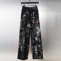 Black wide-leg pants with graphic allover print and elastic waistband