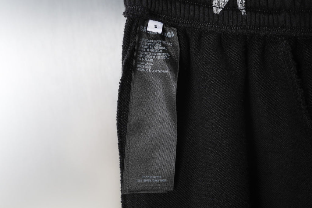 Black pants with care label hanging from elastic waistband