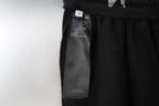 Black pants with care label hanging from elastic waistband
