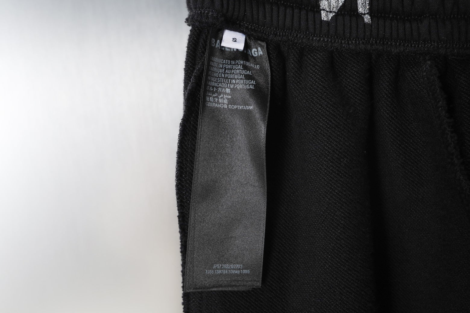 Black pants with care label hanging from elastic waistband