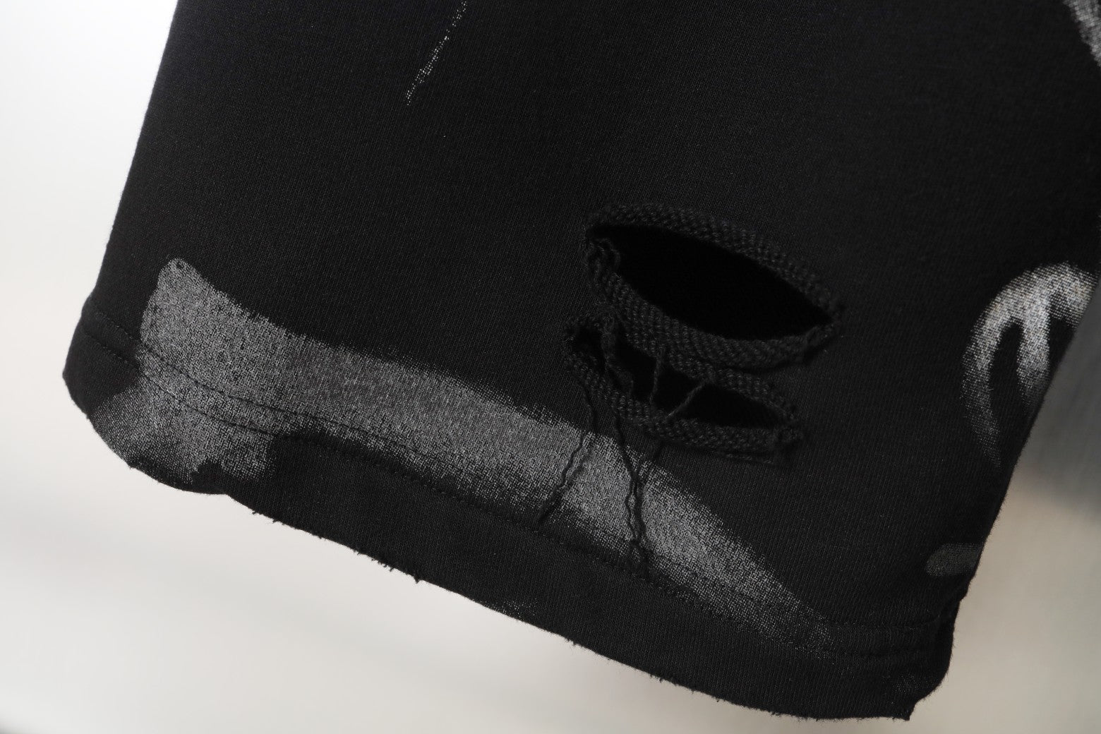 Black pants hem with hidden drawstring and textured cuff edge