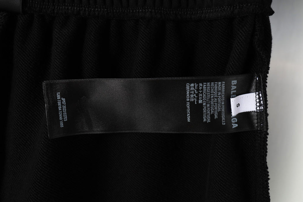 Balenciaga interior label and text on black shorts