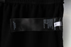 Balenciaga interior label and text on black shorts