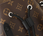 Louis Vuitton monogram backpack corner with black webbed rope and metal ring.