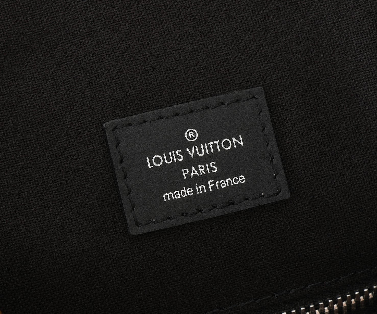 Monogram backpack leather patch reading “LOUIS VUITTON PARIS made in France”