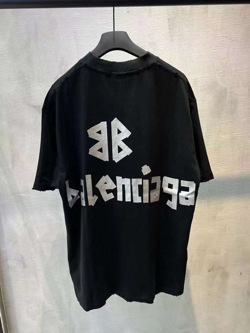 Black short-sleeve T-shirt with white BALENCIAGA logo and graphic on back
