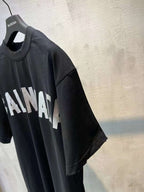 Black short-sleeve T-shirt on hanger with partial white logo text