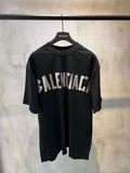 Black short-sleeve T-shirt with large white BALENCIAGA logo across front