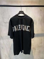 Black short-sleeve T-shirt with large white BALENCIAGA logo across front