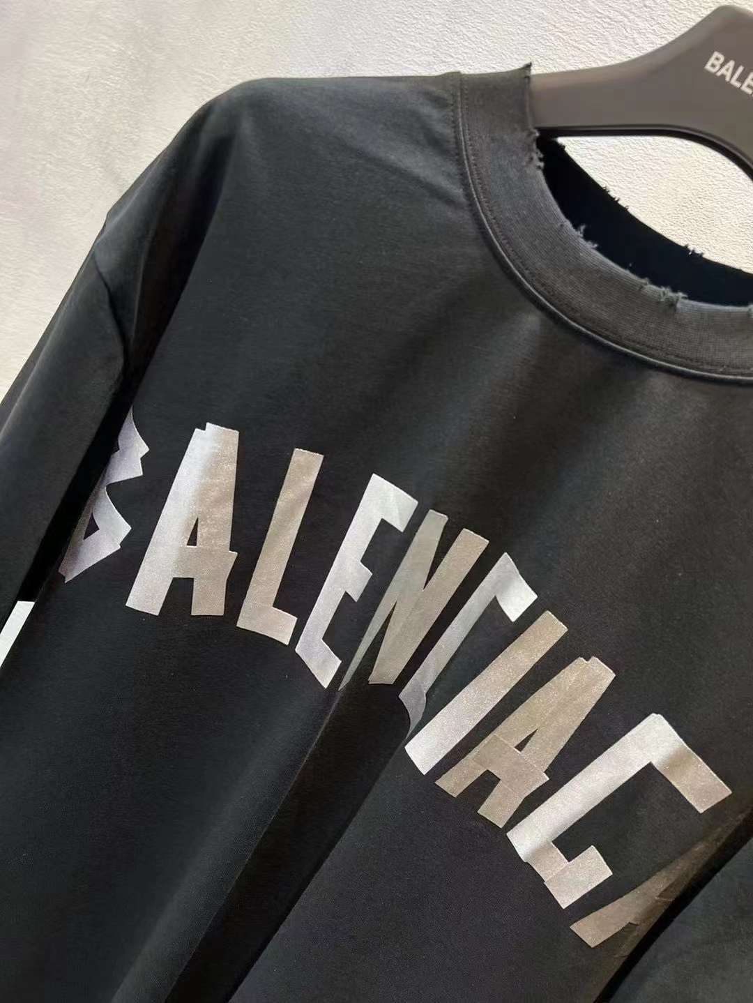 Black short-sleeve T-shirt with white BALENCIAGA logo print at chest