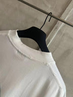 White crew-neck T-shirt collar and shoulder seam detail
