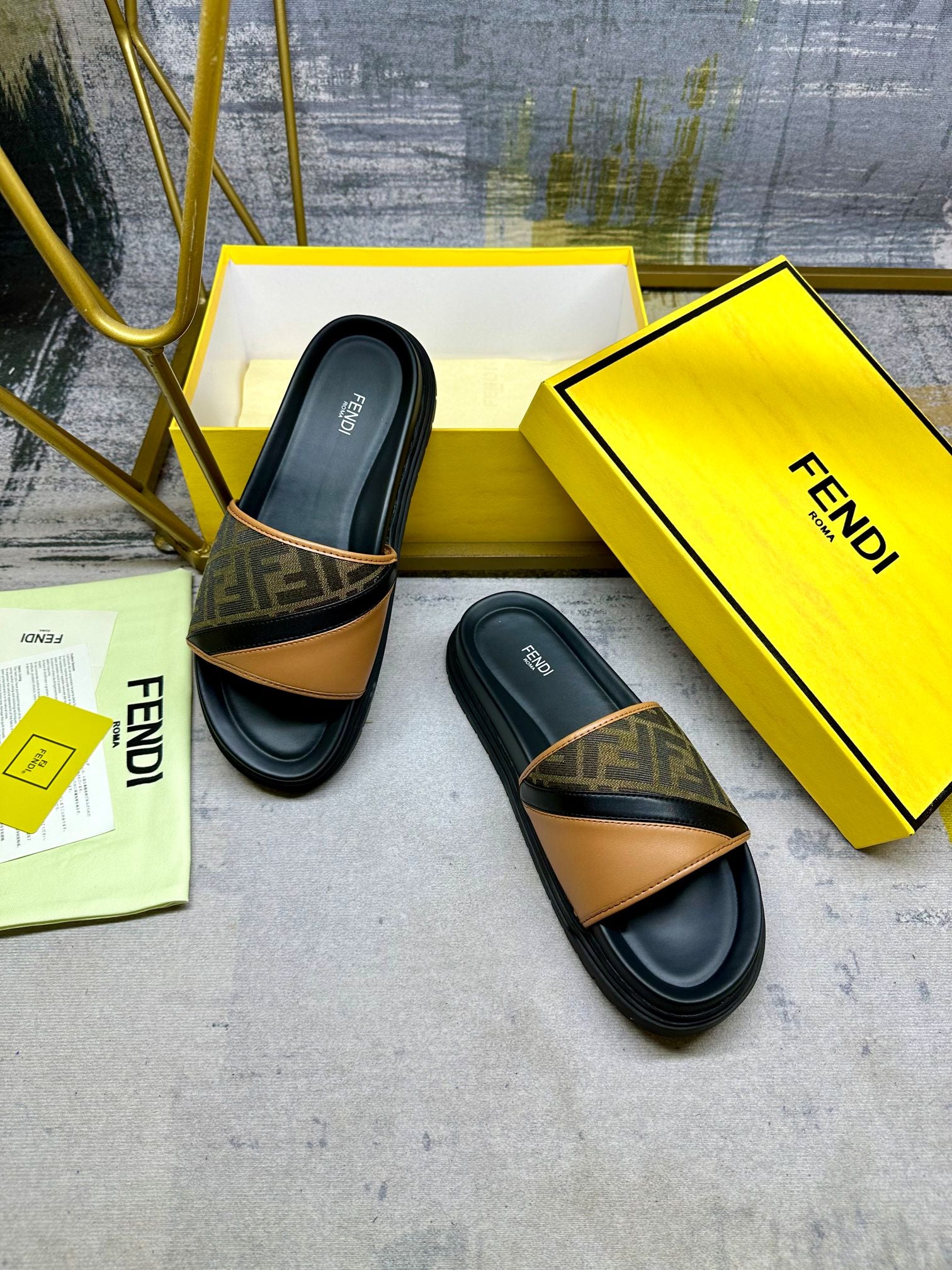Black Fendi slide sandals with FF monogram strap bands and tan leather panel