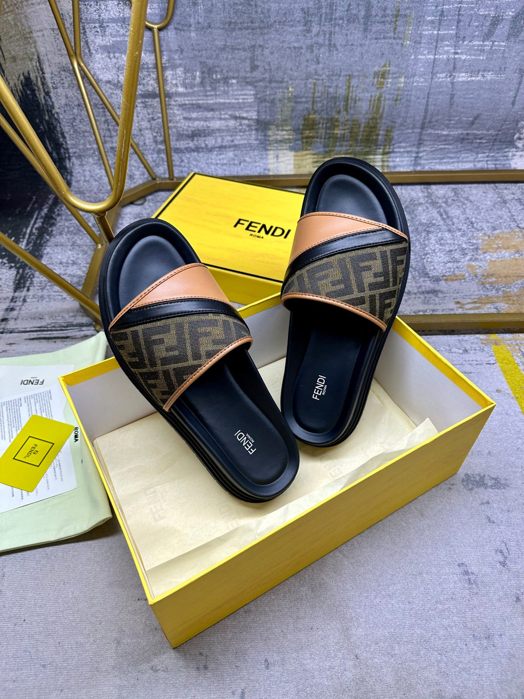 Black Fendi slide sandals with FF monogram straps and tan leather trim, slip-on