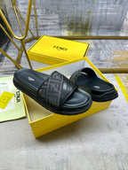Black Fendi slide sandals with FF strap and logo footbed, angled pair.