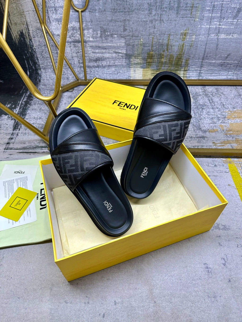 Black Fendi slide sandals with FF-pattern bands, low profile slip-on, side view.