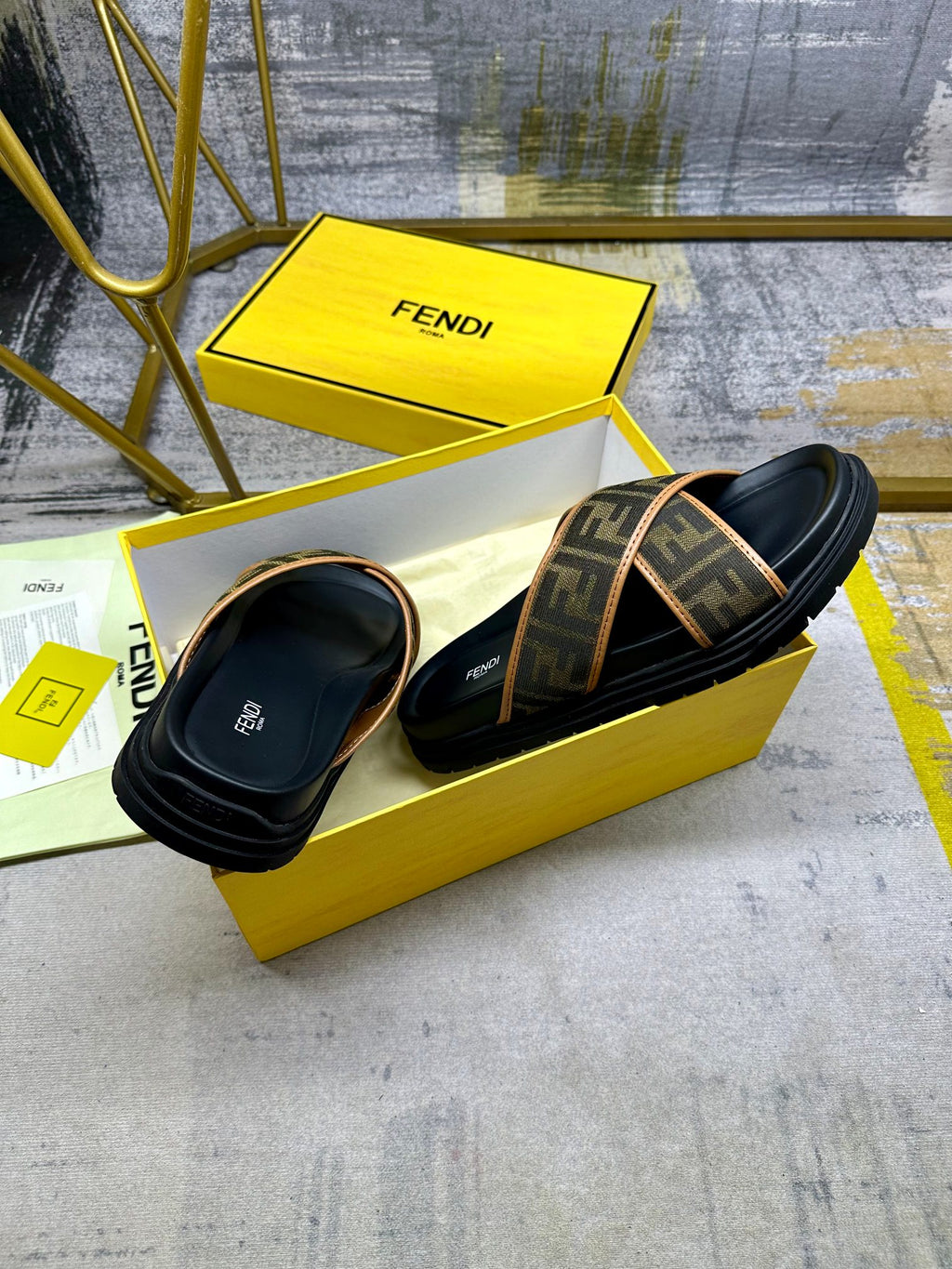 Fendi slide sandal with tan FF-pattern strap and dark rubber sole