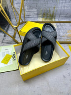 Black Fendi FF slide sandals with wide crossover straps and contoured footbeds