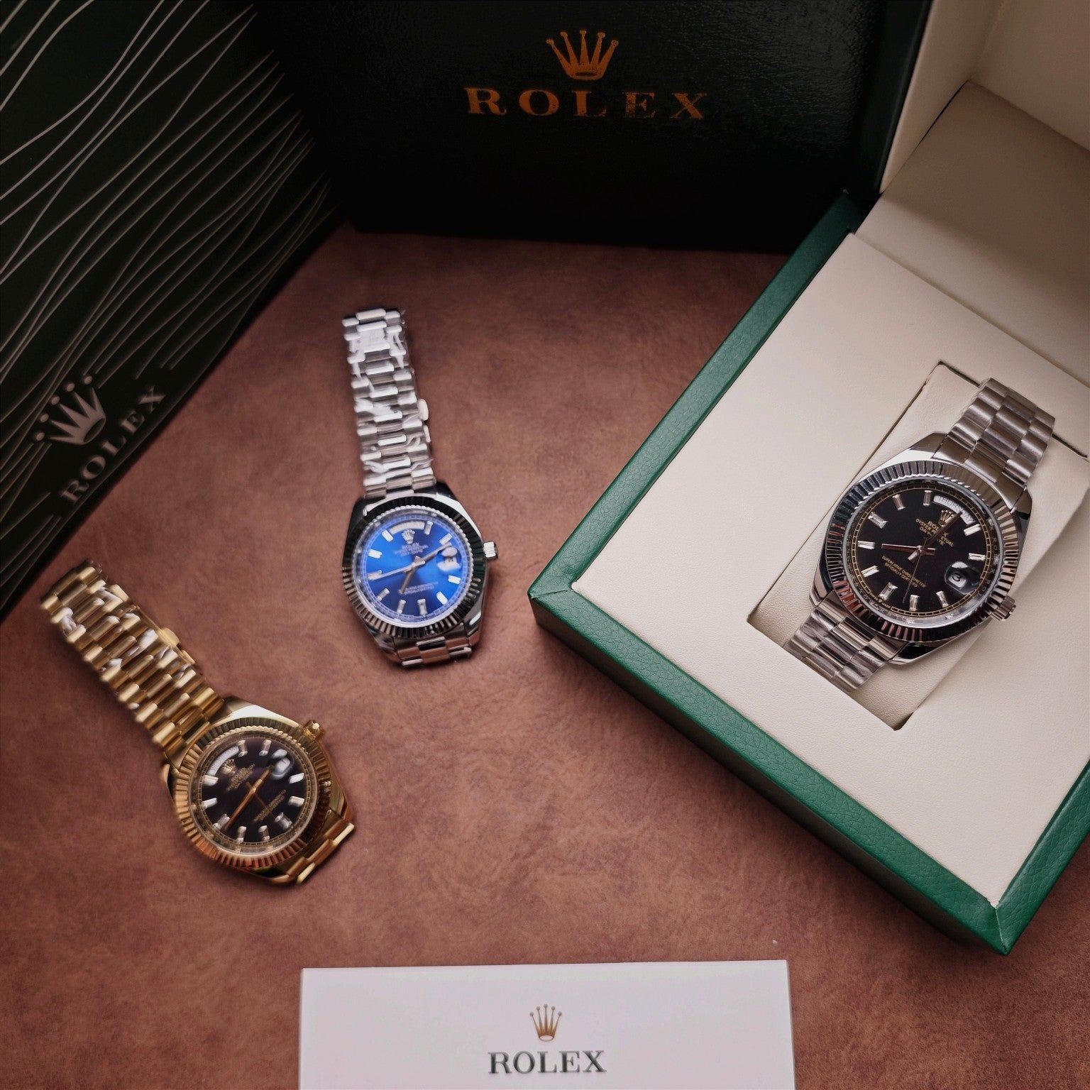 Rolex watch set on display: blue-dial and black-dial wristwatches with metal bracelets