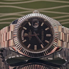 Rolex Day-Date wristwatch with black dial and silver-tone metal bracelet, date window at 3