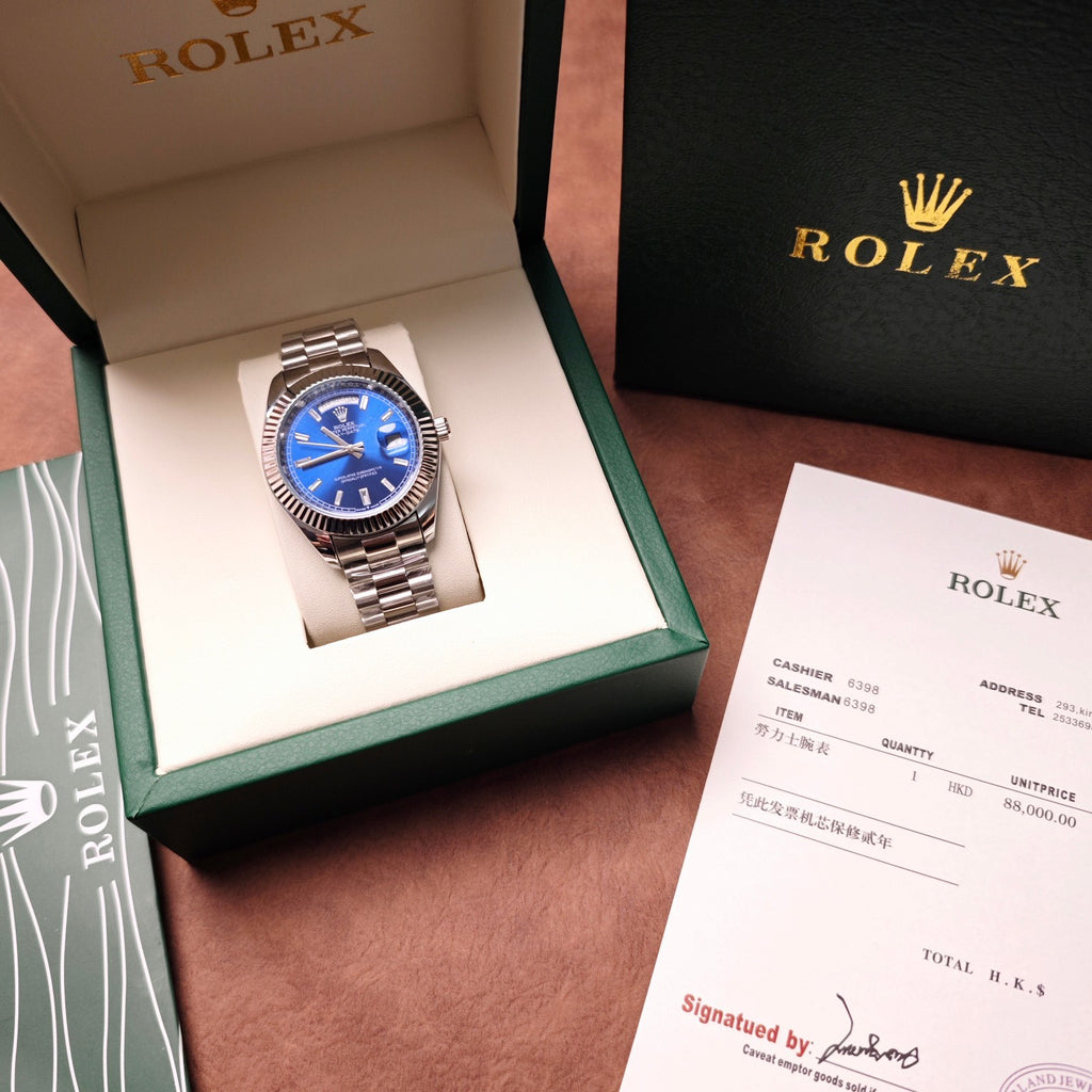 Stainless steel Rolex wristwatch with blue dial in green presentation box