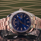 Stainless steel Rolex day-date wristwatch with blue dial and date window at 4