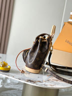 Louis Vuitton monogram mini backpack with adjustable shoulder strap and gold hardware