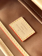 Louis Vuitton monogram bag interior close-up of stitched label and red accent stripe